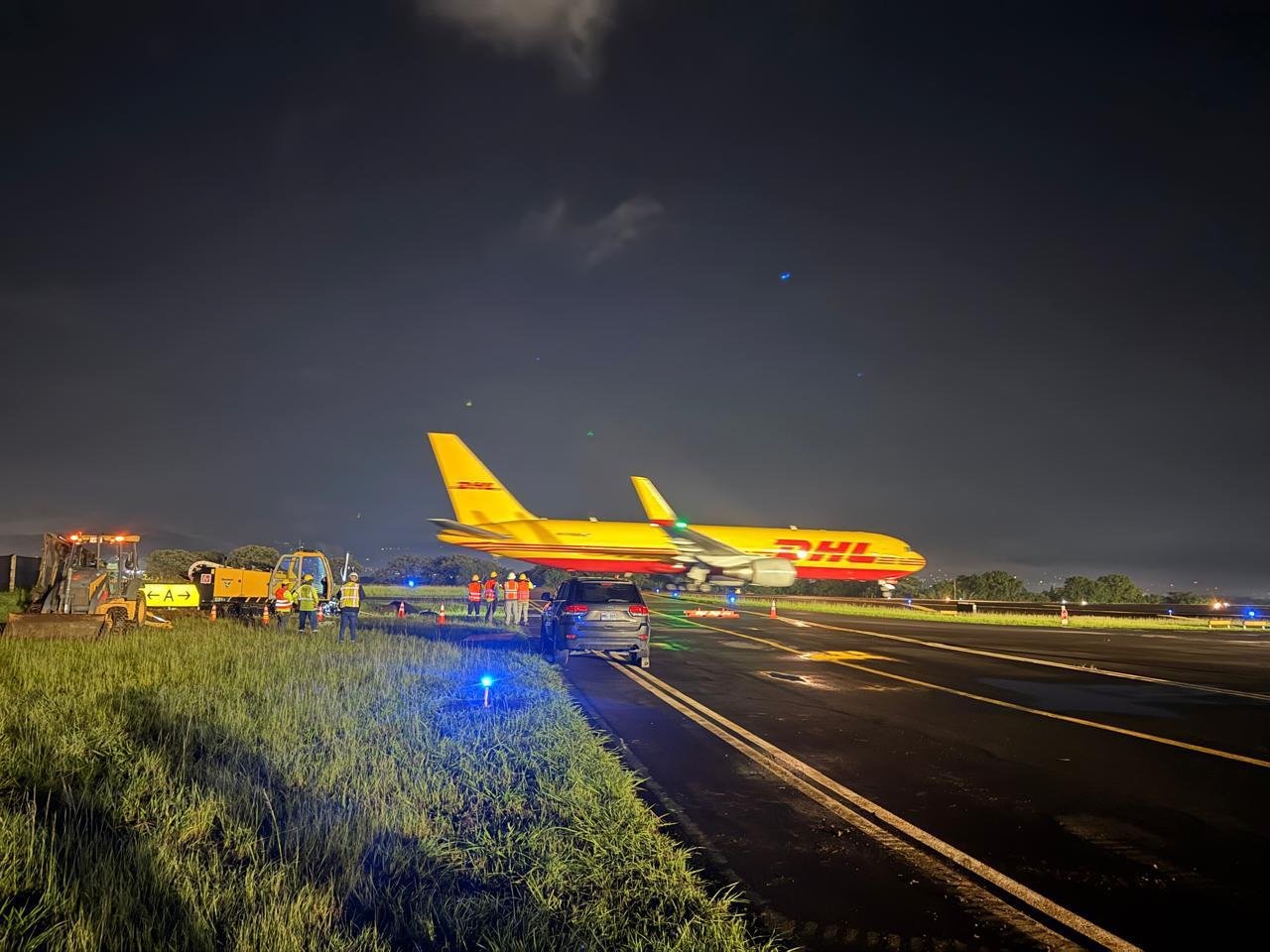Crew working at night beside an airport runway
