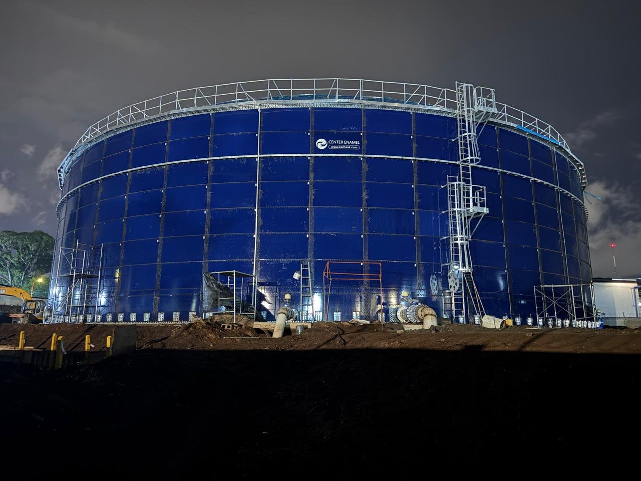Blue glass-fused-to-steel tank illuminated at night